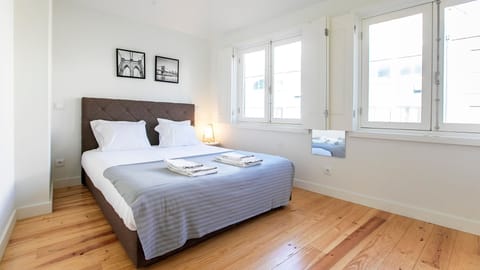 Retreat to this expansive bedroom, where bright windows welcome the day, and easily transform it into a serene haven for deep sleep using the elegant room-darkening shutters, combining comfort with practicality. Enjoy a spacious and organized retreat desi