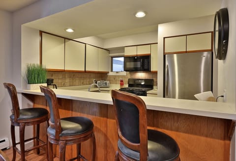 View from dining to fully equipped kitchen