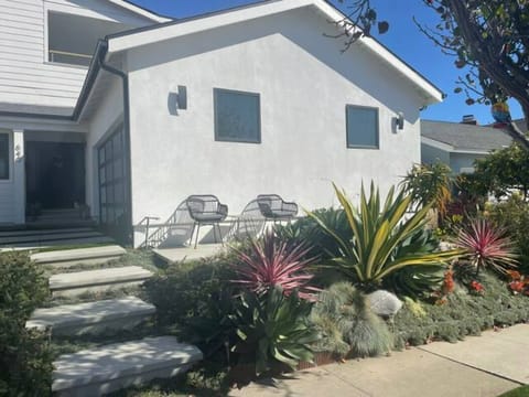 Beautiful succulent garden in the front with a nice little seating area.