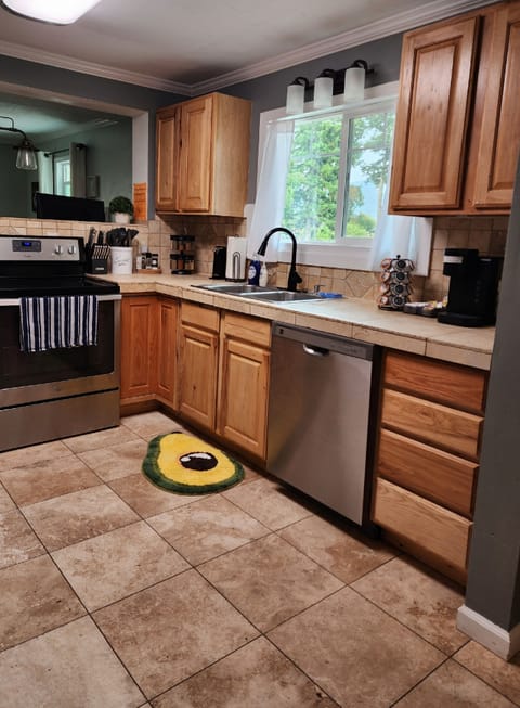 All windows have shades, knife set, utensils, spices, oven, microwave, blender