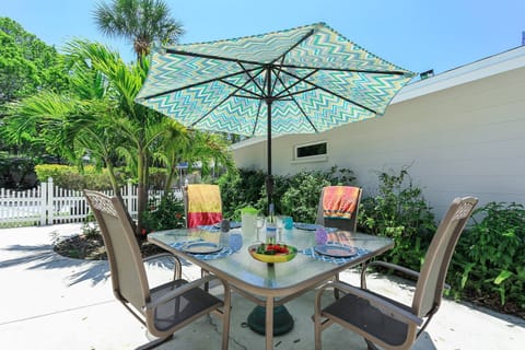 Outdoor open patio with dining for 4 under some shade