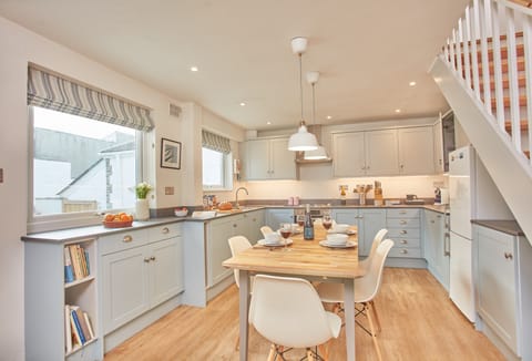 3 Overcliff, Port Isaac. Ground floor: Kitchen with electric oven and hob, Nespresso coffee machine, washer/dryer and dining table seating eight guests.