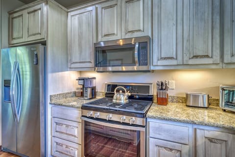 Kitchen with stainless steel appliances, and granite countertops.
