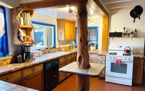 Large fully equipped kitchen with unique tree island.