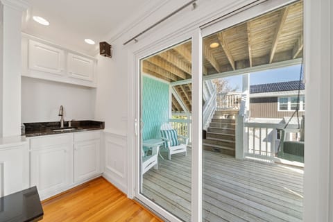 Wet bar with access to the second floor porch