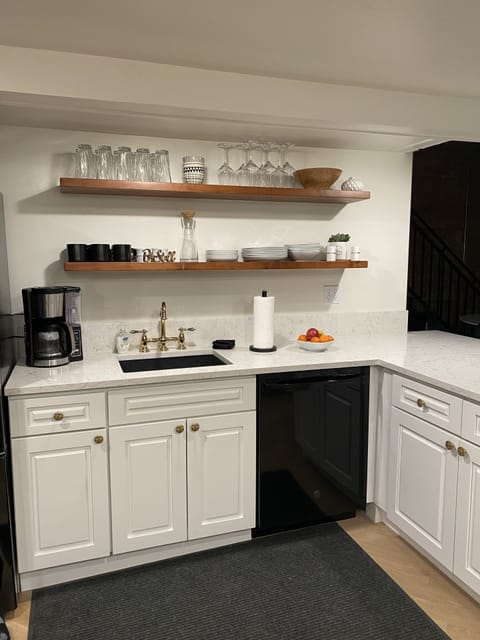 Fully equipped kitchen with a dishwasher, French door refrigerator, & gas range.