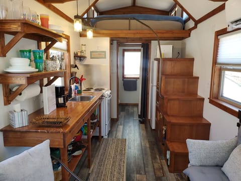 Stairs to the loft bedroom are on the right.