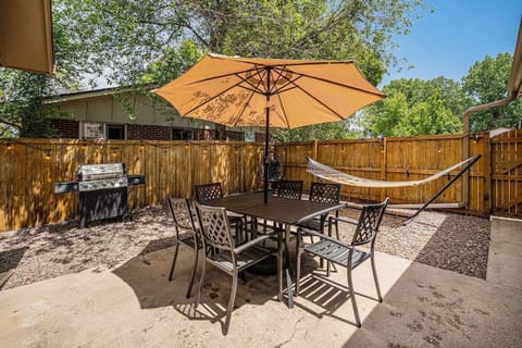 - Dine outdoors under a large umbrella with seating for six and shady comfort
- Propane grill sits nearby perfect for weekend barbecues or easy dinners
- Surrounded by trees and fencing this cozy space feels private and relaxed

