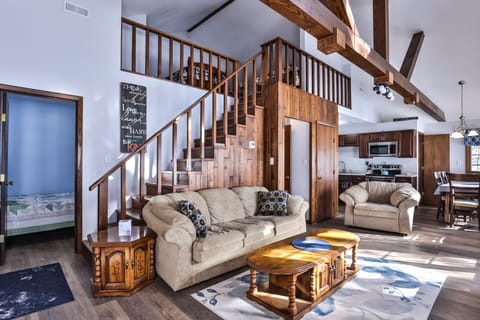 Beautiful wooden stairs leading a spacious loft area