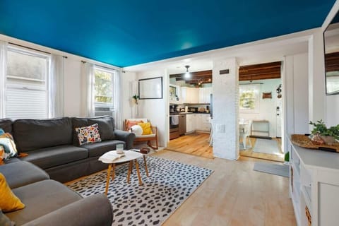 Bright and open living room with wraparound couch with pull-out! Great space for entertaining and games with the family.