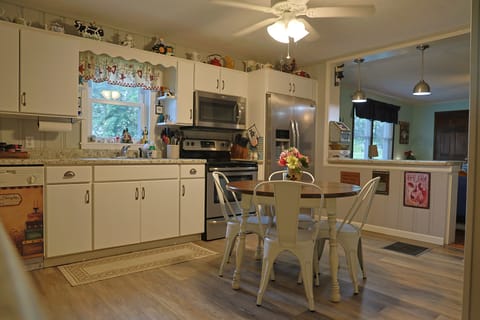 Table has a leaf that can be added and extra chairs are in utility room.