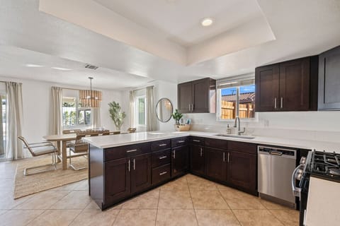 Open kitchen w/ dark cabinetry, ample counter space & room to gather.