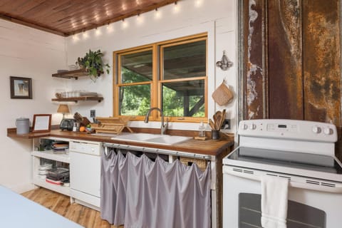 Kitchen, fully stocked with cookware, serving dishes, utensils, and more