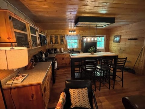 Cabin kitchen with warm wood and black accents for a modern look.