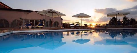 Seasonal outdoor pool, open 10:00 AM to 6:00 PM, pool umbrellas