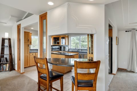 Your open kitchen flows seamlessly into the dining area, where warm wood finishes and granite counters create the perfect space for cooking and gathering.