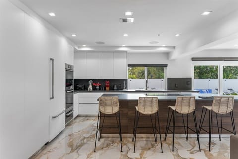 View of the kitchen island that can accommodate more guests.