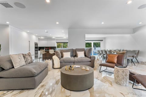 Spacious living room with comfortable sofa and arm chairs great for coffee break