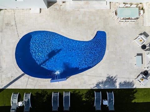 Pool in a drop shape with its own waterfall. Come jump in!