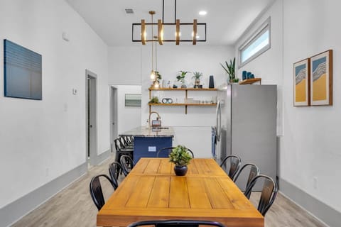 Modern & Stylish Dining & Kitchen Space!Gather around this spacious dining table and enjoy meals in a beautifully designed open-concept kitchen. This space is perfect for cooking and dining, featuring sleek finishes, open shelving, and warm lighting.