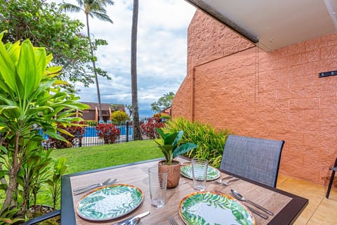 A tropical dining setting awaits on your private patio, with lush gardens and pool views framing your morning coffee or sunset meal.