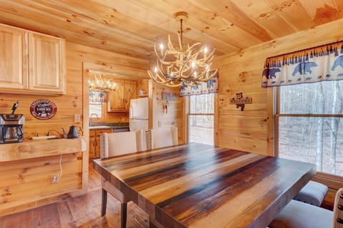 Kitchen just off dining area for easy access. Antler chandeliers add to vibe.