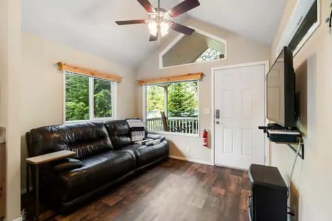 Living room with smart tv, electric fireplace, and reclining  leather sofa