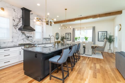Savor your meals in this charming kitchen equipped with modern appliances and a countertop that comfortably seats four, combining style, convenience, and warmth.