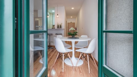 Step out onto the charming balcony or enjoy a delightful meal at the dining table, bathed in soft light from the expansive windows. This inviting space seamlessly connects indoor comfort with a refreshing outdoor feel.