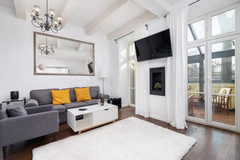 Bright living area with a stylish sofa and large windows.
