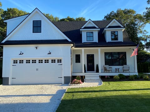 Front of the home with seashell driveway and covered porch for morning coffee.