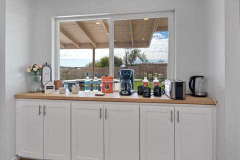 Coffee bar with coffee, cream, sugars teas, syrups and electric kettle