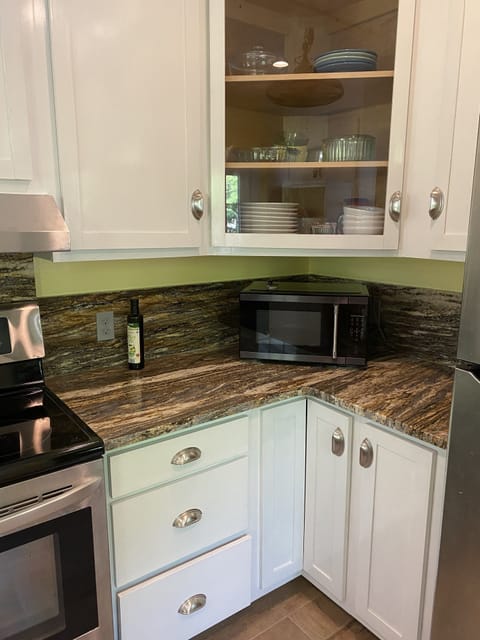 Newly renovated kitchen with granite countertops and stainless appliances .