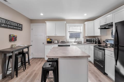 New kitchen with island, & automatic ice maker.