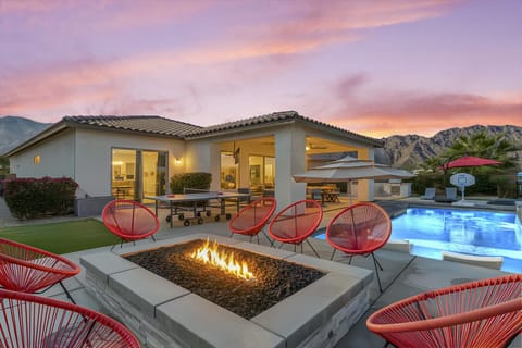 Backyard firepit lounge w/ modern seating, ideal for evenings under the sky