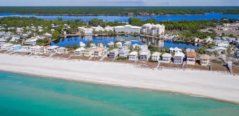 Stunning beachfront community with pristine white sand beach and turquoise waters stretching along the coastline.