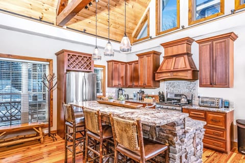 Open Kitchen for interaction with guests, TV, and fireplace.