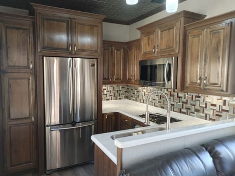 kitchen with full size fridge fully stocked even a dishwasher
