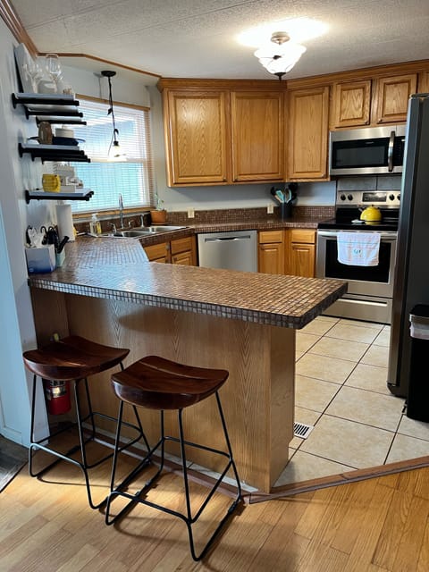 The kitchen is loaded with all appliances, plenty of utensils and dishes.