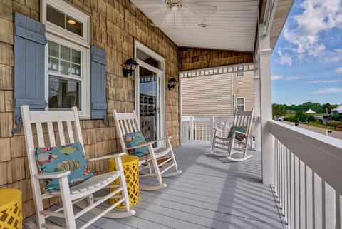 Welcome your guests and neighbors from the shaded front porch! 4 rocking chairs.