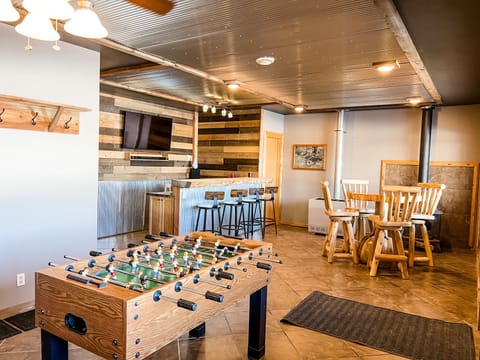 Basement bar with games and foosball.