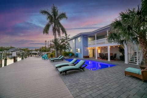 Beautiful heated pool and deck area with ample seating and peaceful surroundings.