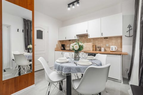 A small dining space with a round table, modern chairs, and a minimalist design.