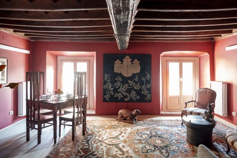 Another view of the wide living room with the windows overlooking the square