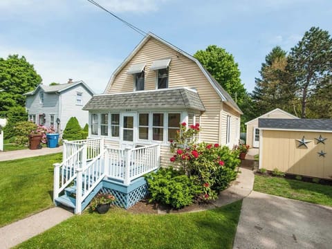 Cottage front with small deck and sunroom