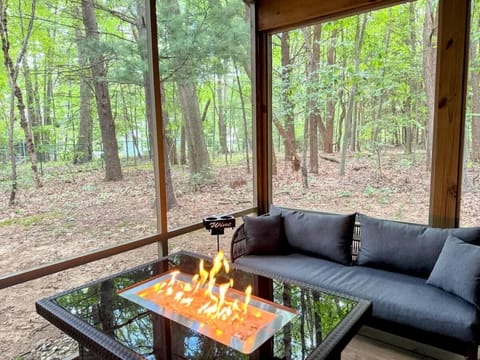 Wrapped in trees and screened for comfort, this porch is a guest favorite - perfect for slow sips, deep talks, and watching fireflies rise while the flames flicker.