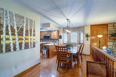 The dining room is well lit, with natural light and a large fixture.