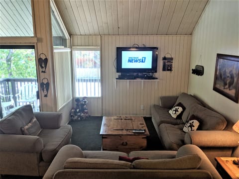 Living Room with lots of windows and slider to upper deck