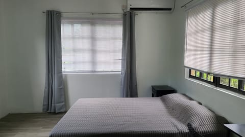 Large queen  bed with A/C and plenty of natural light from large windows