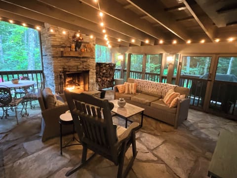Screened porch with wood burning fireplace & gas starter, tv and grill
